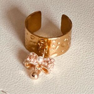 Elegant Gold Bow Ring with Pearl Accent.
